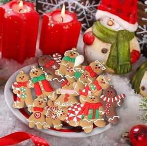 Close-up of gingerbread man ornaments in various outfits on a white holiday festive plate
