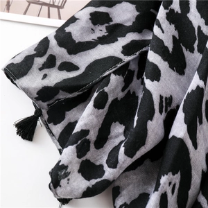 Close-up of leopard print scarf with black fringe and lightweight cotton-linen texture