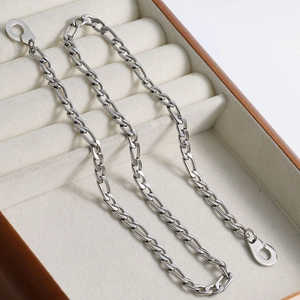 Detail of silver Figaro chain necklace with round lobster clasp on jewelry box
