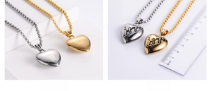 Detail view of heart pendants in gold and silver showing size on a ruler and matte back
