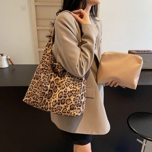 Retro leopard print tote bag with beige pouch shown on model in urban street setting