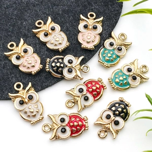 Macro view of colorful enamel owl alloy pendants with rhinestone eyes for DIY jewelry
