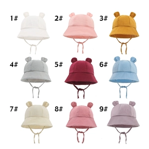 Infant cotton bucket hats with bunny ears in nine solid colors and chin straps