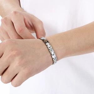 Detailed view of silver and black tungsten steel men's bracelet with magnetic links