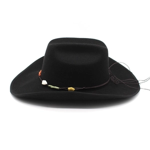 Detailed view of black wool cowboy hat with ethnic style stone beaded rope decoration