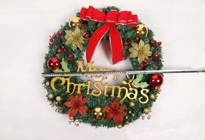 Close-up of a 50cm Christmas wreath with red bow, gold ornaments and glitter flowers