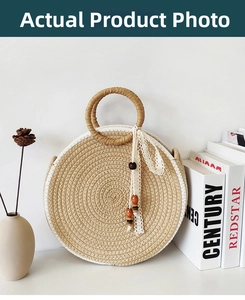 Detail of round straw handbag featuring woven texture and white lace ribbon decoration