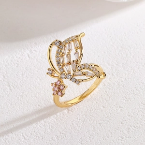 18K gold plated butterfly and pink flower ring with zircons on stone surface