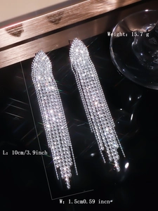 Detail view of silver tassel earrings with crystal rhinestones showing 10cm length