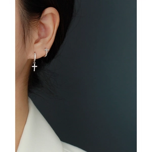 Elegant S925 sterling silver cross earrings with shimmering crystals on model