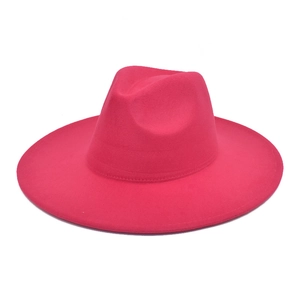 Detail view of the rose red wool fedora hat showing its wide brim and top indentation