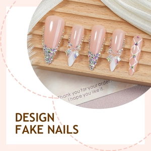 Long pink press-on nails with luxury 3D bows and AB rhinestones on a silk display