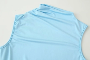 Detailed macro view of the sky blue mesh knit dress neckline and shoulder seams