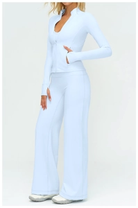 Detail of light blue yoga set with thumb holes, stand collar, and high waist trousers