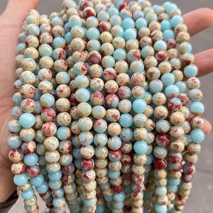 Detailed macro view of sea sediment jasper round beads with blue and red mineral veins
