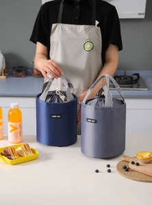 Detail of the drawstring closure and sturdy handles on the cylindrical lunch bag