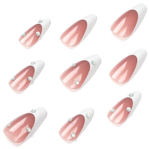 Classic French stiletto false nails with nude base, white tips, and sparkling rhinestones