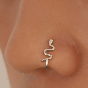 Close-up of a silver non-pierced snake nose clip cuff jewelry on a model's nose