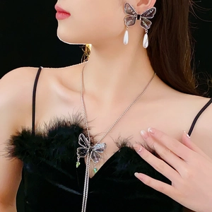 Detail of a sparkling diamond butterfly tassel necklace with elegant fringe on a model