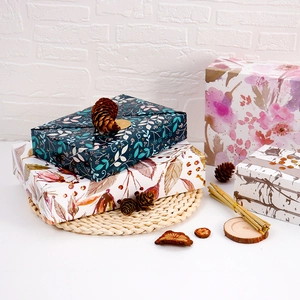 Floral gift wrapping paper with botanical patterns and gold leaf accents for presents