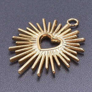 Macro view of 18k gold plated sunburst pendant with hollow heart detail and metal luster