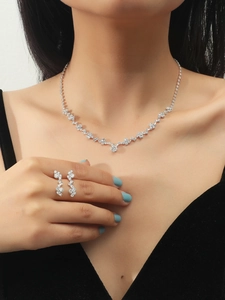 Sparkling silver necklace and earrings set with marquise cut crystals on a model