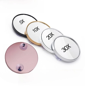 Close-up of magnifying mirrors with suction cups in 5X, 10X, 20X and 30X zoom variants