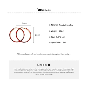 Detail view of leopard print faux leather hoop earrings with dimensions and material specs