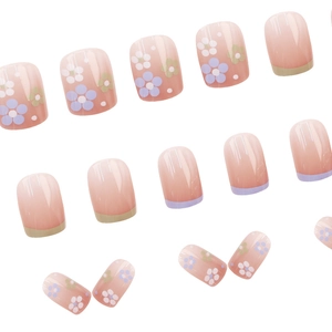 Pastel pink press-on nails with cute floral patterns and two-tone French tips