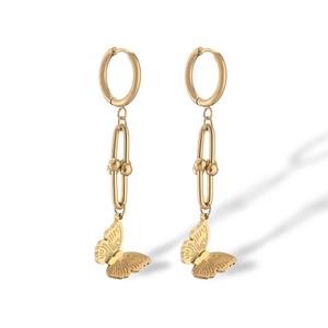 Close-up of gold-plated butterfly drop earrings with delicate chain and huggie hoop