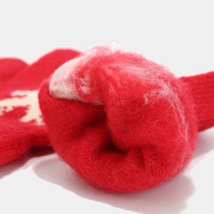 Detail of red knitted fabric with white snowflake patterns and thick warm plush lining