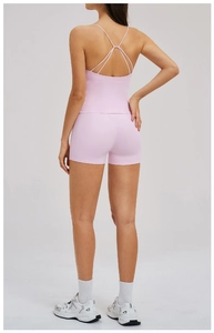 Detail of pink yoga set showing criss-cross back straps and high-waisted shorts