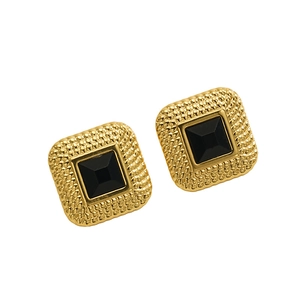 Detailed view of vintage gold-plated square earrings with black gemstone and beaded texture