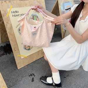 Pink canvas tote bag featuring cute floral rabbit prints and secure snap closure detail
