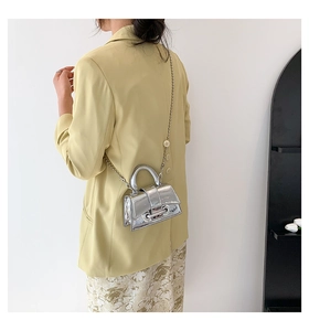 Detail of silver mirror mini bag with beaded metal chain on a female model back view