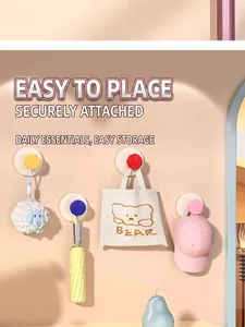 Detailed view of colorful suction wall hooks holding a bag, umbrella, and a hat