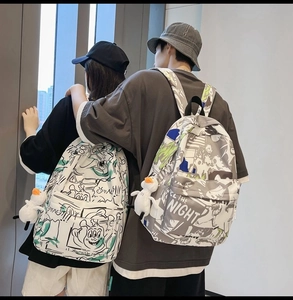 Graffiti printed couple backpacks shown on models to display size and street style fit