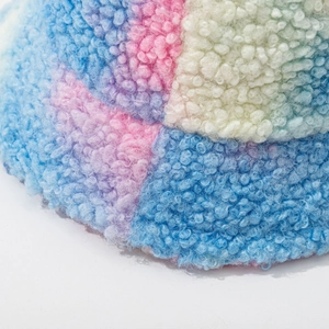 Colorful tie-dye lamb wool bucket hat featuring multi-color patchwork and thick plush texture