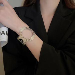 Detailed view of wide hammered silver cuff bracelet with circular cutout on model