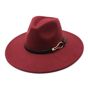 Detail of burgundy wool fedora hat with black leather band and gold metal buckle