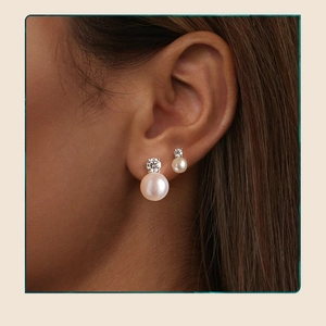 Detail of s925 silver stud earring with pink freshwater pearl and moissanite on model