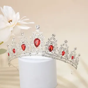 Detailed view of luxury silver tiara with red teardrop gems and white rhinestones