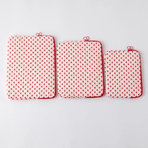 Three-piece quilted laptop sleeve set with red heart pattern and heart-shaped zippers