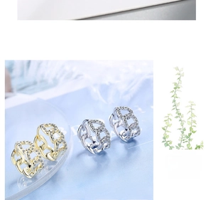 Close-up of gold and silver chain link hoop earrings with pavé zircon settings