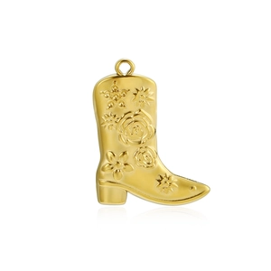 Detail of a 18k gold plated cowboy boot pendant with embossed floral and star patterns