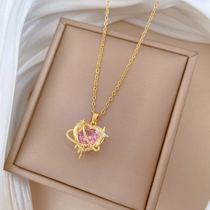Luxurious gold necklace with a pink heart gemstone pendant and a sparkling planet ring