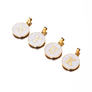 Detail of vintage 22mm gold stainless steel initial pendants N, Y, U, K with shell inlay