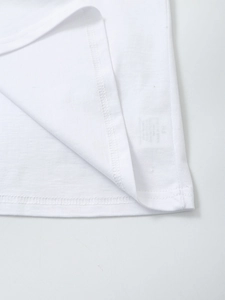 Detail of double-needle stitching and cotton knit texture on a white t-shirt hem