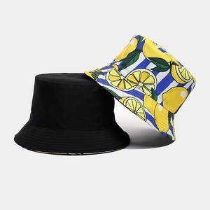 Detail showing reversible cotton bucket hat with classic black and lemon print pattern