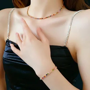 Rainbow cubic zirconia necklace and bracelet set in gold plating on female model